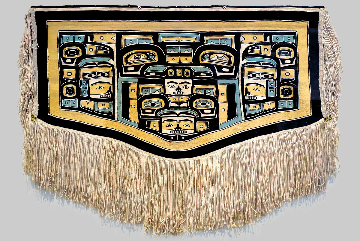 A woven robe with blue, yellow, and black patterns
