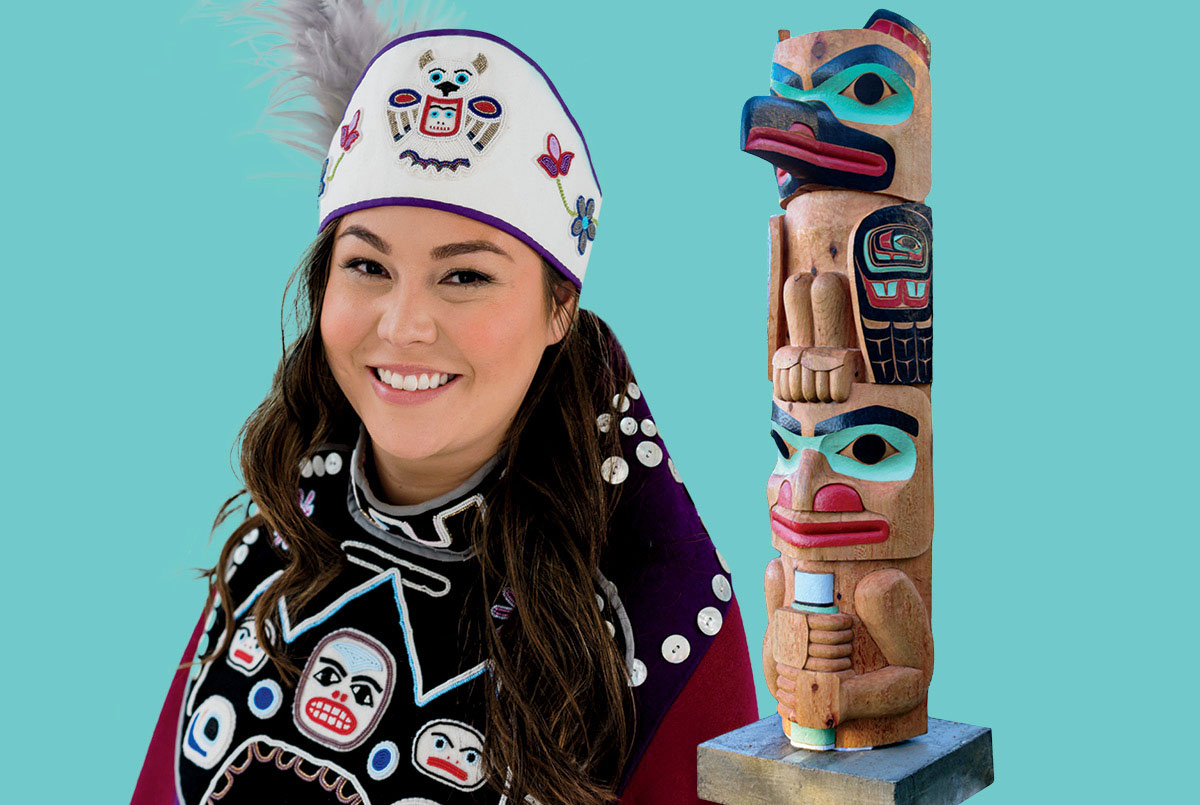Photo of a young person wearing traditional clothing and a totem pole