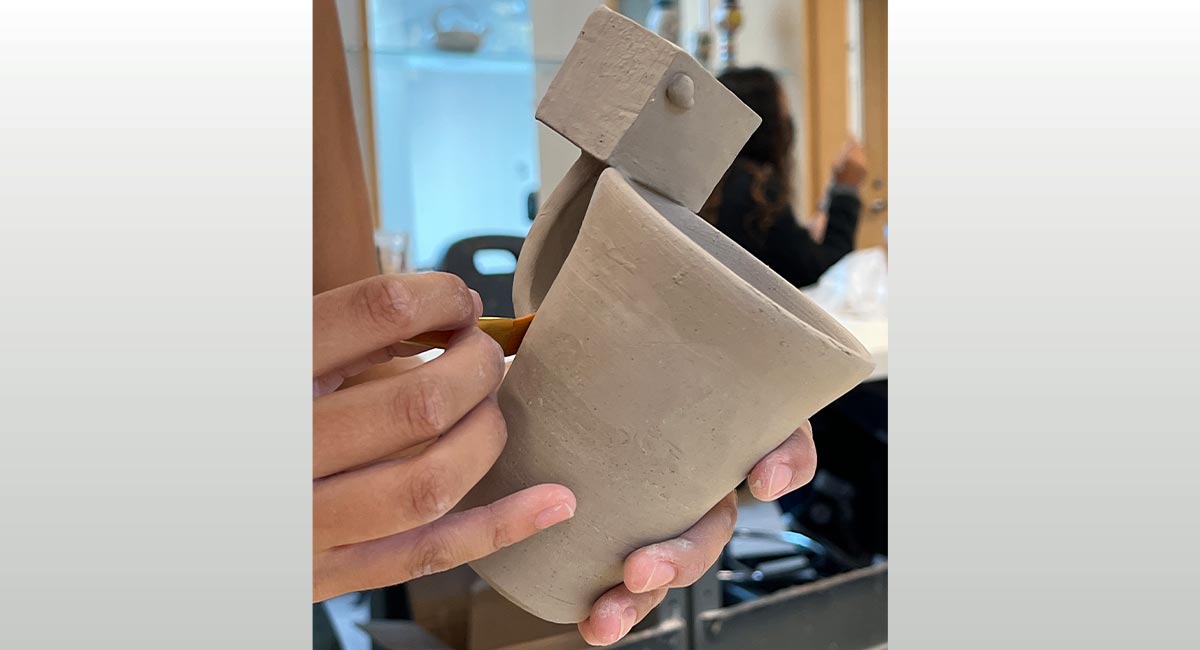Image of hands shaping a mug