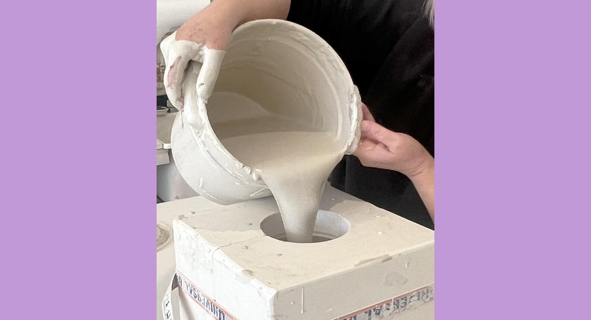 Image of an artist pouring liquid clay